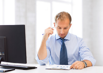 Image showing businessman writing in notebook