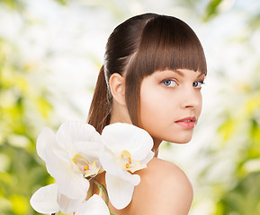 Image showing beautiful woman with orchid flower