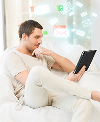 Image showing man sitting on the couch with tablet pc