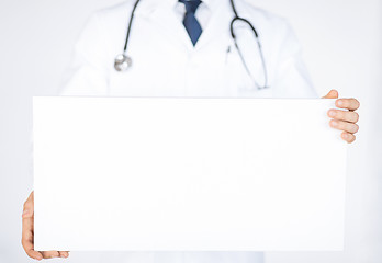 Image showing doctor holding blank white banner