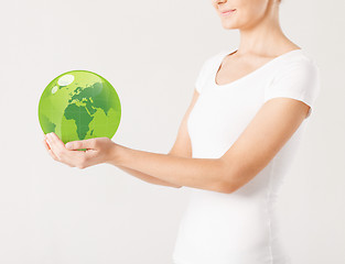 Image showing woman holding green sphere globe