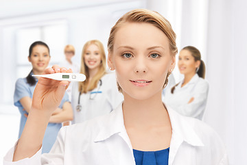 Image showing attractive female doctor with thermometer