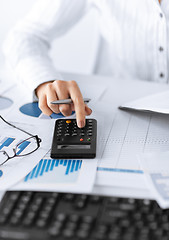 Image showing woman hand with calculator and papers