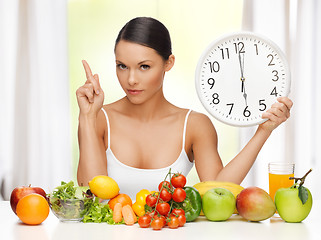 Image showing woman with big clock