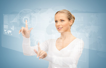 Image showing businesswoman touching virtual screen