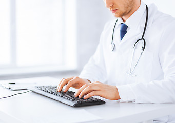 Image showing male doctor typing  on the keyboard