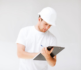 Image showing male architect looking at blueprint