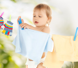 Image showing baby doing laundry