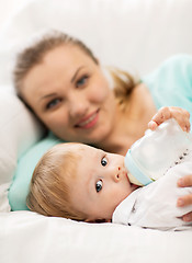 Image showing mother and adorable baby with feeding-bottle