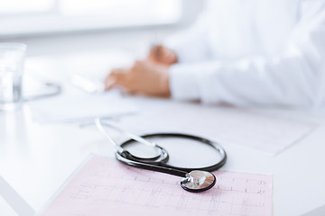 Image showing male doctor hands with cardiogram