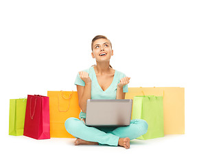 Image showing woman with laptop and shopping bags