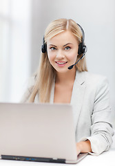 Image showing friendly female helpline operator with laptop