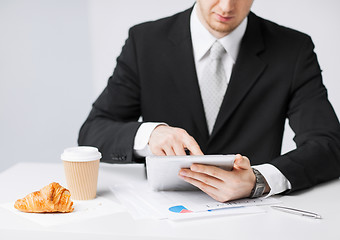 Image showing man with tablet pc and cup of coffee