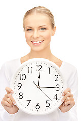 Image showing businesswoman with wall clock