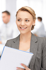 Image showing happy woman with big notepad