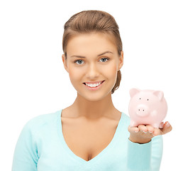 Image showing lovely woman with small piggy bank