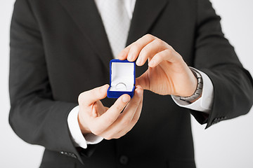 Image showing man with gift box and wedding ring