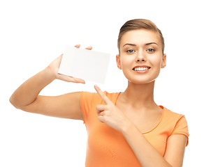 Image showing smiling woman pointing at white blank card