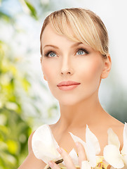 Image showing woman with white orchid flower