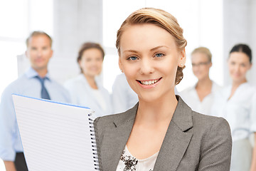 Image showing happy woman with big notepad