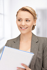 Image showing happy woman with big notepad