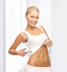 Image showing woman with arrows on her stomach