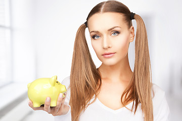 Image showing lovely woman with piggy bank