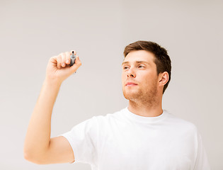 Image showing man writing something in the air