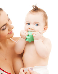 Image showing curious baby biting toy