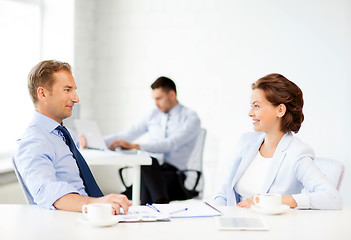 Image showing man and woman discussing something in office