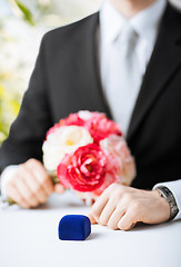 Image showing man with gift box in suit