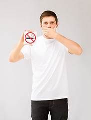 Image showing young man holding no smoking sign