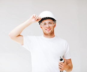 Image showing male architect in helmet with blueprint