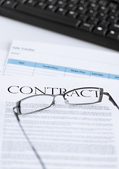 Image showing signed contract paper with glasses