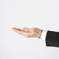 Image showing mans hand showing something