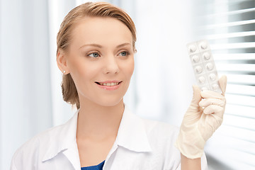 Image showing attractive female doctor with pills