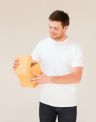 Image showing man in white t-shirt with gift box