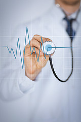 Image showing doctor hand with stethoscope listening heart beat