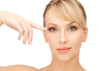 Image showing beautiful woman touching her eye area