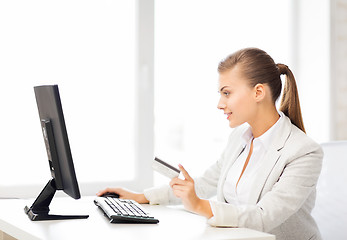 Image showing businesswoman with computer using credit card