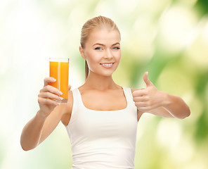 Image showing woman holding glass of orange juice