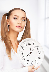 Image showing woman holding big clock