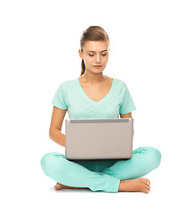 Image showing young girl sitting on the floor with laptop
