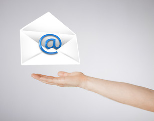 Image showing hand holding envelope with email sign