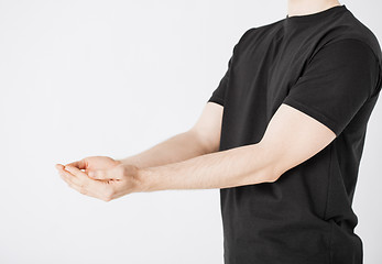 Image showing mans hands showing something