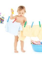 Image showing baby doing laundry