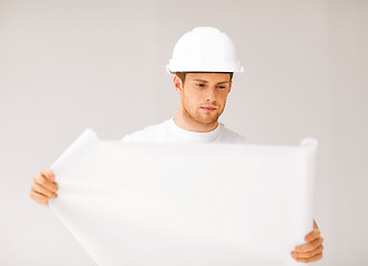 Image showing male architect looking at blueprint