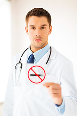 Image showing male doctor holding no smoking sign