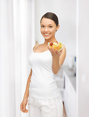 Image showing healthy woman holding bowl with fruit salad