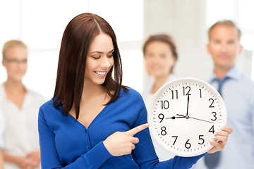 Image showing woman holding big clock